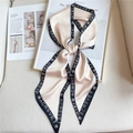 Detail of silk-satin scarf with black trim and floral pattern on an art book background - Beige with Black Edge (LE-17) / 147x14cm