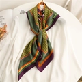 Houndstooth pattern silk-like scarf in purple and orange draped on a white shirt - Green Purple Border