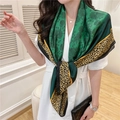 Dark green silk-feel scarf with floral and leopard prints, worn by model in a bright room - Dark Green Floral Leopard Border (FE38-2)
