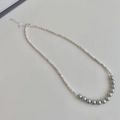 Close-up of beaded necklace featuring silver-tone accent beads and 10 grey pearls - String of Grey Pearls Necklace