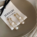 Detail of gold chain tassel earrings with freshwater baroque pearls on jewelry card - Freshwater Pearl Tassel Earrings