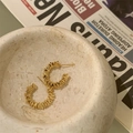 Detail of gold C-shaped hoop earrings with textured stack effect on a stone bowl - Large / Gold