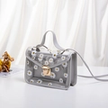 Grey translucent crossbody jelly bag with white daisy prints and gold metal buckle - Gray