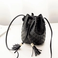 Minimalist black embossed leather bucket bag with tassel drawstring and golden accents - Black