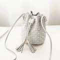 Light gray bucket bag with geometric texture, dual tassels, and drawstring closure - Gray