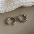 Detailed view of silver hoop earrings with vertical ribbed texture and polished finish - Silver Threaded Ear Buckle