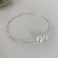 Macro detail of silver beaded choker with white pearls on a minimalist white background - Crushed Silver Pearl Choker