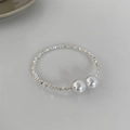 Close-up of elastic silver beaded bracelet with two large pearls in minimalist design - Broken Silver Mixed Pearl Bracelet