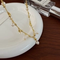 Detail shot of vintage freshwater pearl tassel necklace on white porcelain tray - Elegant Pearl Tassel Necklace
