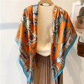 Elegant 110cm orange paisley silk scarf with blue border shown on a mannequin - Warm Orange Lake Blue Paisley (FE138-1)