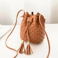 Caramel brown drawstring bucket bag with circular embossed texture and double tassels - Brown