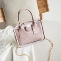 Chic pink transparent PVC tote with inner pouch and gold chain strap on sofa - Purple