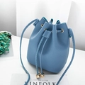 Light blue faux leather bucket bag with drawstring and gold metal sphere charms - Blue