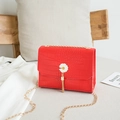 Sac bandoulière rouge texture crocodile avec chaîne dorée et breloque marguerite - Rouge