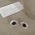 Macro view of vintage black zircon stud earrings with silver hammered metal finish - Silver Black Zirconia Earrings