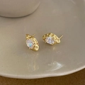 Detail of vintage gold-plated earrings featuring oval clear zircon with hammered metal texture - Gold White Zirconia Earrings