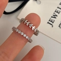 Close-up of stacked zircon leaf ring and shimmering silver band set on finger - Zircon Leaf Open 2-Piece Set / Silver