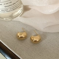 Detailed close-up of polished gold C-shape stud earrings on elegant textured background - Gold