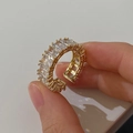 Macro shot of gold plated adjustable ring with square zircon baguette stones - Gold