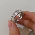 Macro shot of silver plated open ring with sparkling rectangular cubic zirconia crystals - Silver