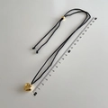 Macro shot of 3D gold heart pendant with black cord and adjustable gold beads - Small Gold Heart Pendant Black Rope Style (B-293)