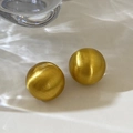 Detail of golden brushed metal spherical earrings with a minimalist matte finish texture - Round Brushed Gold Style