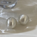 Detail shot of silver spherical earrings with a brushed matte finish and water shadow - Round Brushed Silver Style