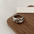 Macro detail of a matte grey irregular minimalist wrap ring on a rustic wooden tray - Matte Silver Irregular Staggered Overlay Ring