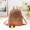 Brown mini sequin backpack with cat ear detail and gold logo on leather surface - Brown