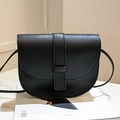 Classic black saddle bag with pebble grain leather and vertical decorative strap design - Black