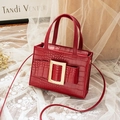 Elegant dark red crossbody bag with crocodile texture and golden buckle on white lace - Red