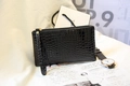 Elegant black faux crocodile skin clutch bag with gold zipper and wrist strap detail - Black