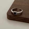 Macro detail of silver-toned textured ring featuring a black heart-shaped center - Silver Black Zirconia