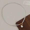 Close-up of pearl necklace featuring a golden hollow ring and large pearl pendant - Gold Hollow Ring Large Pearl Necklace B-307