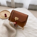 Brown crossbody chain bag with glitter flap and golden twist lock on white plush - Brown