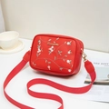 Red leather crossbody bag with floral embroidery and wide fabric shoulder strap - Red