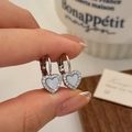 Close-up of micro-paved heart earrings with mother of pearl inlay and D-shaped hoop buckles - Silver