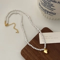 Close-up of pearl necklace with gold heart pendant on a wooden display stand - 10# / Gold