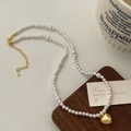 Detail of elegant pearl necklace featuring a golden heart pendant on a wooden tray - 12# / Gold