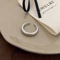 Detail of minimalist silver open ring on a ceramic plate with elegant gift card - Thin Band Open Style / Silver