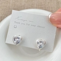 Detailed macro shot of French retro zircon heart hoop earrings on a white card display - Silver White Zirconia