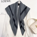 Detailed view of large square silk scarf with geometric letter print and rolled edges - Black Frame Dark Blue Geometric Monogram (FN10-3)