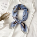 Blue silk scarf with golden equestrian horsebit print tied in an elegant bow - 70x70cm / Haze Blue