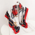 Close-up of luxury twill silk scarf with vintage carriage and crown print pattern - 90x90cm / Red