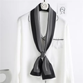 Elegant black and white striped skinny silk scarf tied as a bow on a white satin shirt - Black Stripe