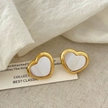 Detailed close-up of heart-shaped gold earrings with white mother-of-pearl inlay - Gold Heart