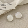 Close-up of minimalist silver geometric stud earrings with mother of pearl inlay on fabric - Silver Round