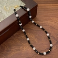 Elegant beaded necklace with black faceted stones, white pearls, and gold-tone lobster clasp - Black Crystal Pearl Necklace