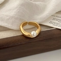 Detailed macro view of an elegant matte gold ring featuring a single white pearl accent - Gold Irregular Pearl Ring (C-333)