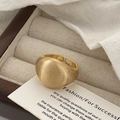 Macro detail of a wide brushed gold adjustable ring placed on a jewelry display card - Brushed Style / Adjustable Open / Gold